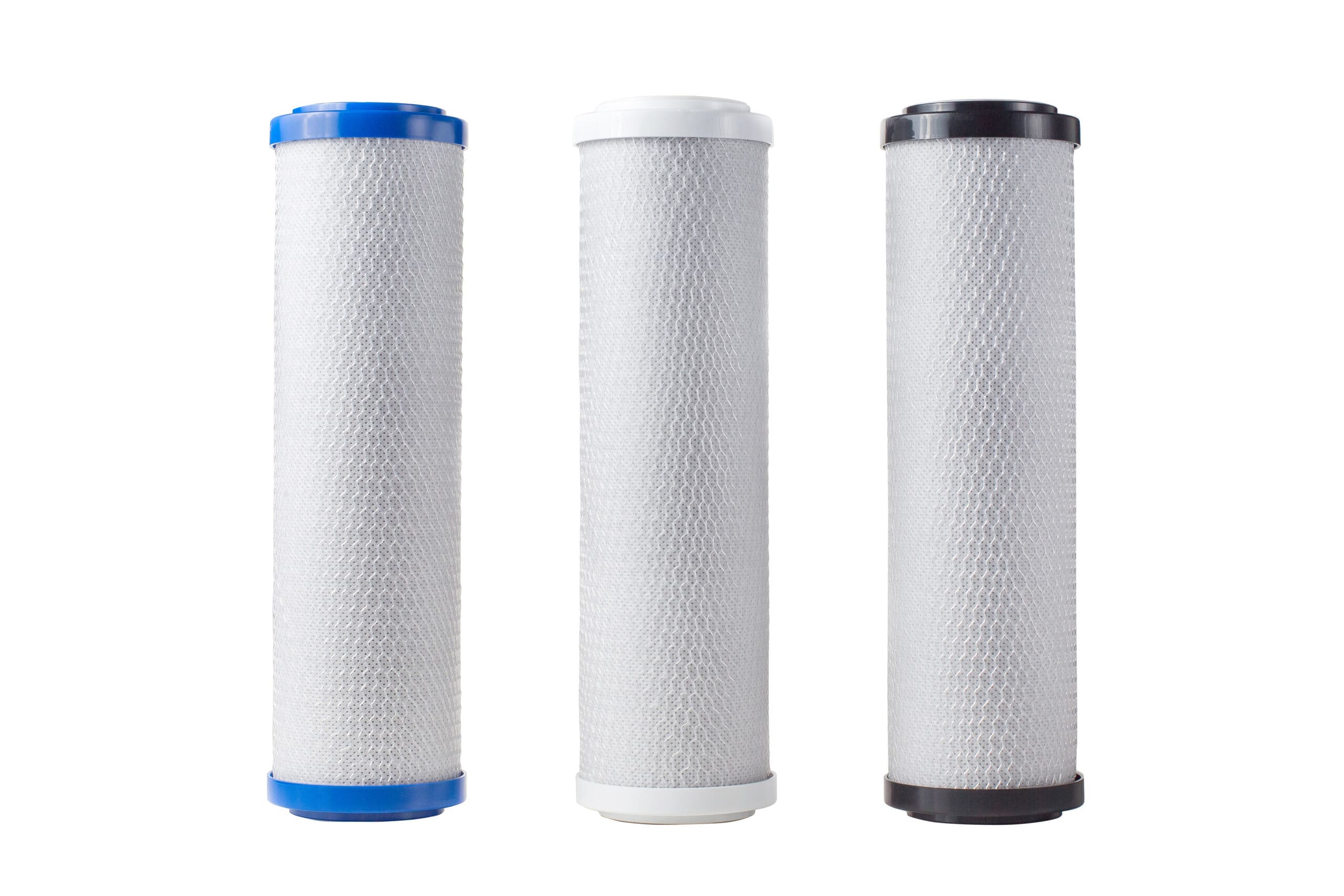 Three carbon block water filter cartridges with colored end caps for industrial filtration systems
